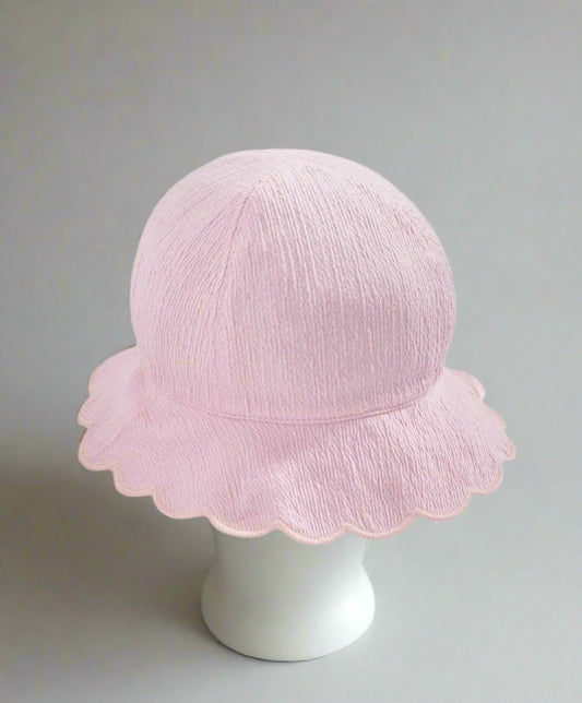 Pink reversible bucket hat with scalloped brim