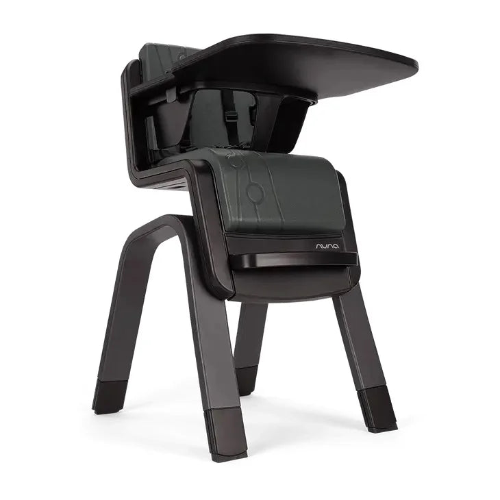 High chair three-quarter view with dark seat cover and curved back shell