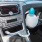 White and blue bottle warmer in a car cup holder with bottle inside