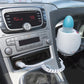 White and blue bottle warmer installed in a car cup holder