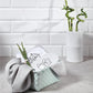 Hooded bamboo towel 100x100 laid in basket, gray-and-white animal face print