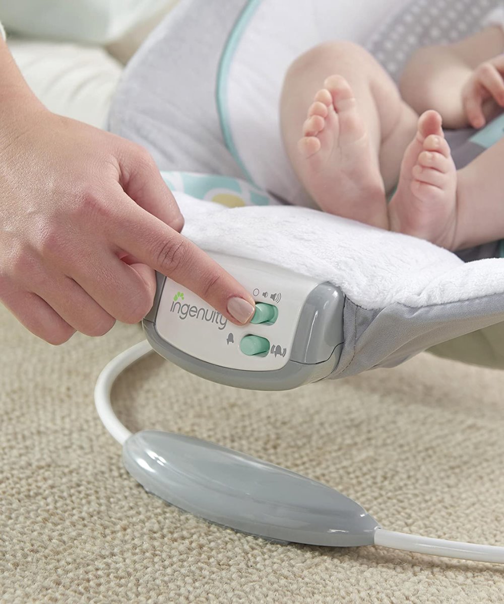 Infant bouncer control panel with printed Ingenuity logo on grey base