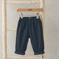 Jersey lined trousers, dark navy with elastic waistband and cuffed hem, hanging view