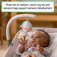 Baby in grey rocking seat with plush mobile toy and dangling fabric tags