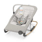 Grey baby rocking seat with padded cushion, toy bar, and vibration control base