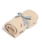 Cream knitted blanket rolled with bow tie and small multicolor motifs