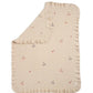 Cream knitted blanket with ruffled edges and small multicolor charm motifs
