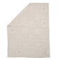 Light grey knitted blanket with small scattered motifs, square fold.