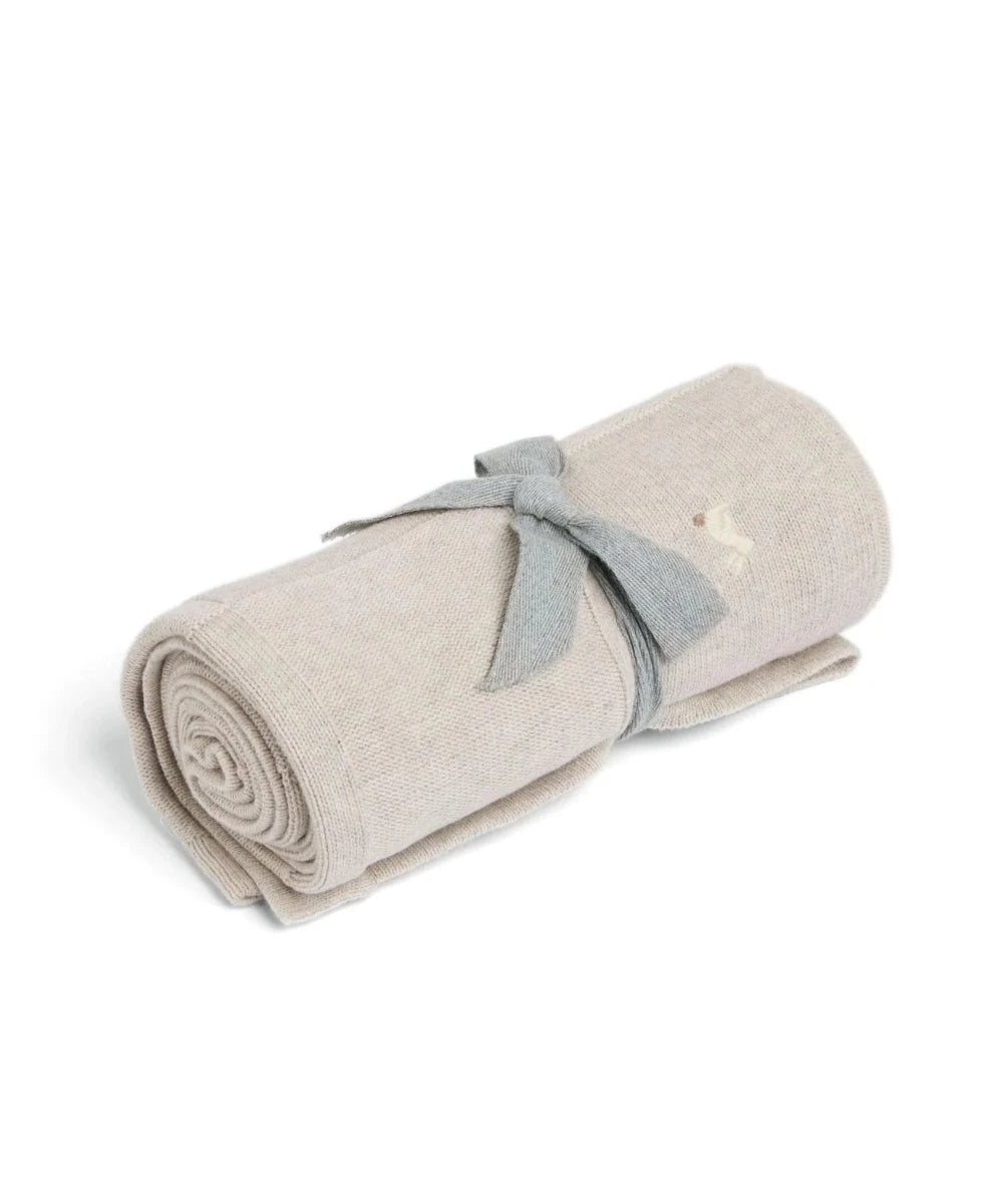 Light grey knitted blanket, rolled with blue fabric tie.