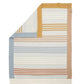 Knitted striped blanket folded over, featuring tan, cream, blue, and rust stripes
