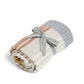 Rolled knitted blanket with multi colour horizontal stripes and tied ribbon