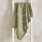 Sage green knitted blanket with safari animal print and ribbed border