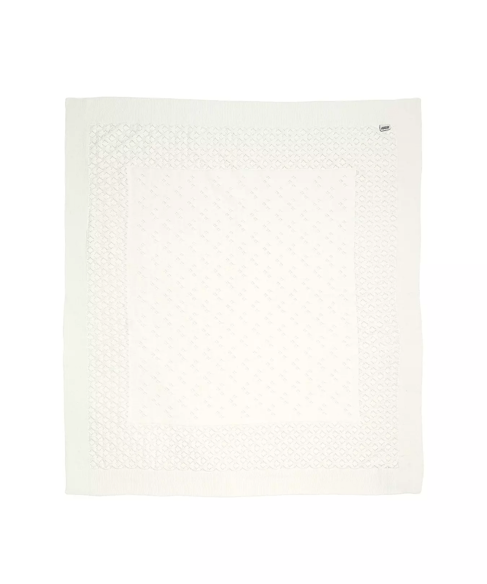 Small knitted blanket in white with diamond pattern border and solid center