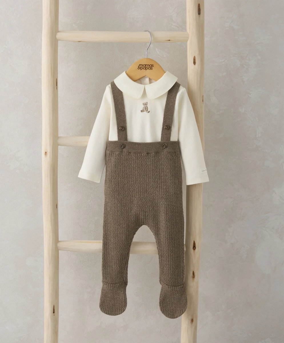 Cream long-sleeve bodysuit with teddy applique and brown knitted dungarees, front
