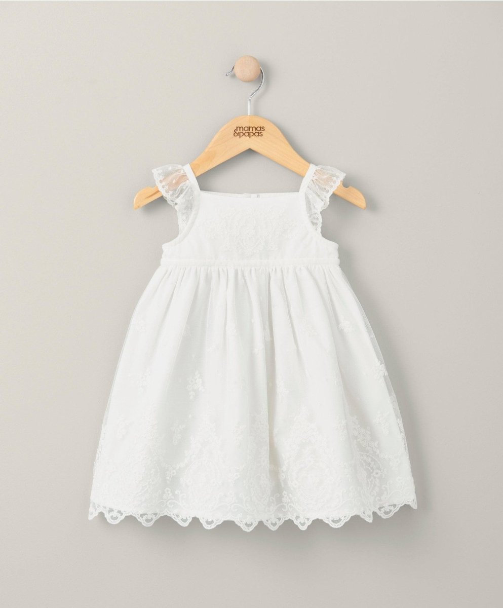 White lace baby dress with sleeveless bodice and scalloped lace hem
