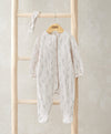 Cream floral footed baby onesie with long sleeves and matching headband
