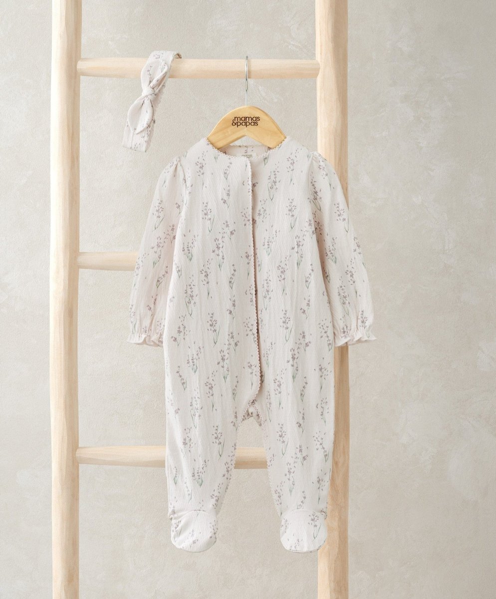 Cream floral footed baby onesie with long sleeves and matching headband