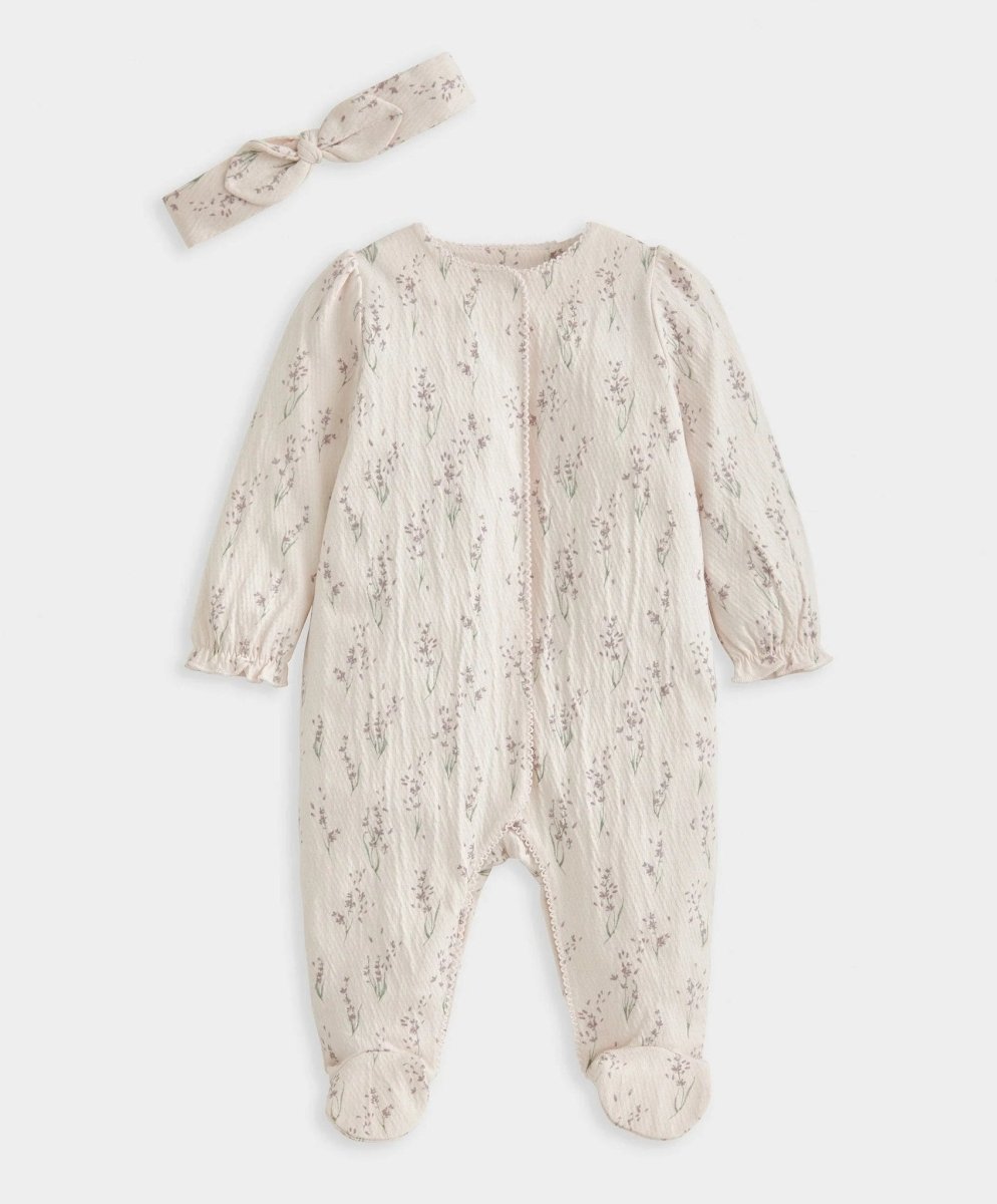 Cream floral long sleeve footed baby onesie with round neckline