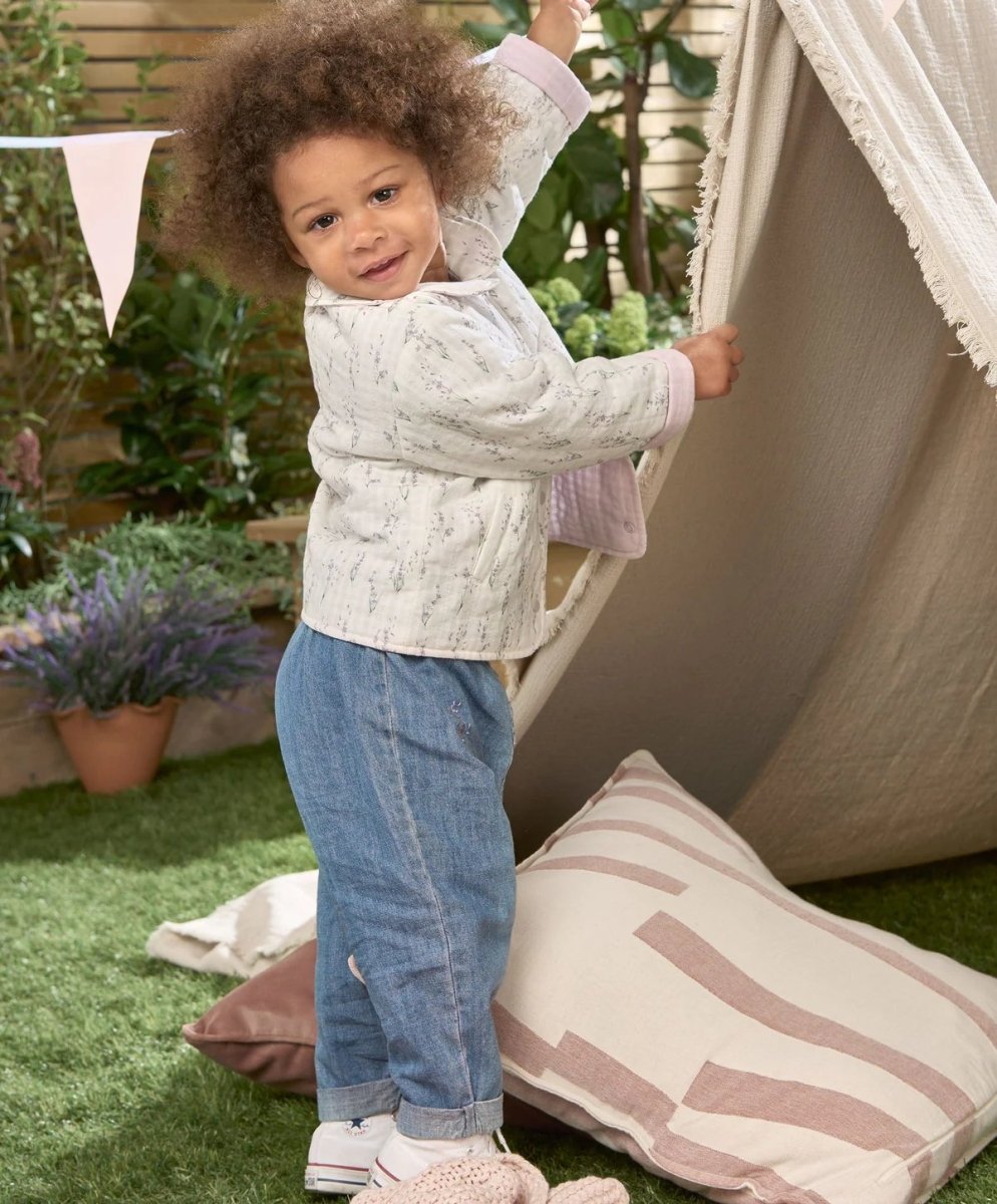 Light blue denim jeans on toddler, embroidered details on legs, elastic waist
