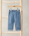 Light blue denim jeans with small embroidered motifs, elastic waist
