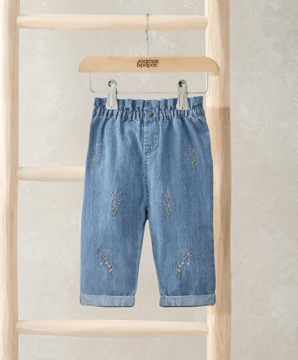 Light blue denim jeans with small embroidered motifs, elastic waist