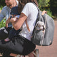 Grey changing bag worn with shoulder straps, front zipper, and exterior pockets