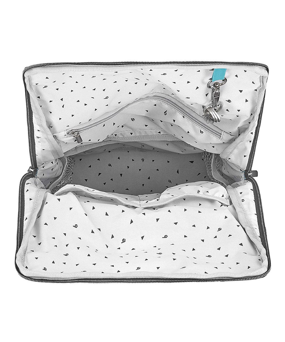 Grey changing bag interior with zippered storage and dotted lining.