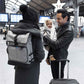 Grey changing bag backpack worn on the back with black shoulder straps.