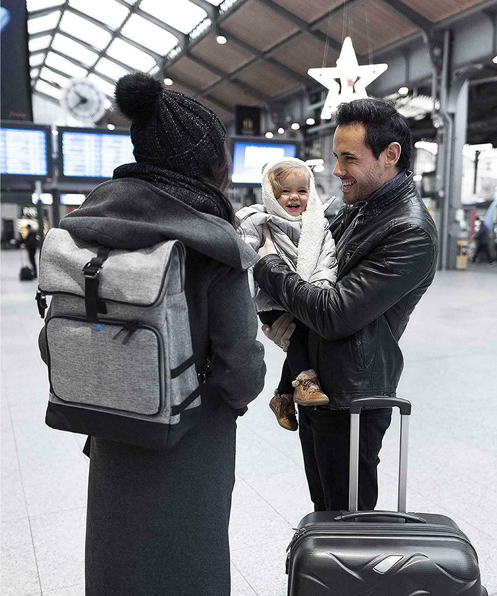 Grey changing bag backpack worn on the back with black shoulder straps.