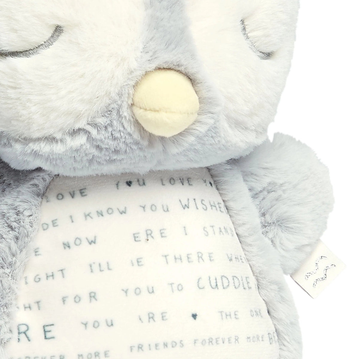 Light gray plush owl with cream nose and embroidered belly text panel