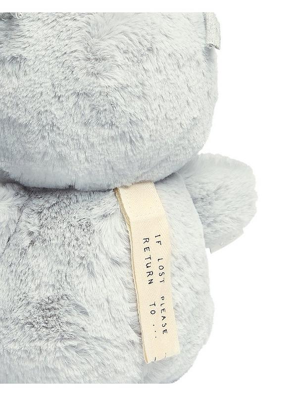 Light gray plush sensory owl with fabric tag and stitched foot detail