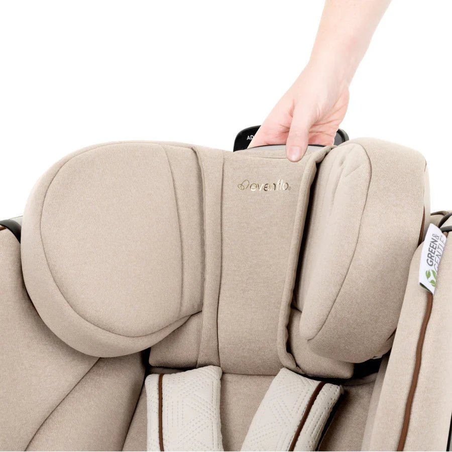 Champagne car seat headrest with recline handle, shown close-up