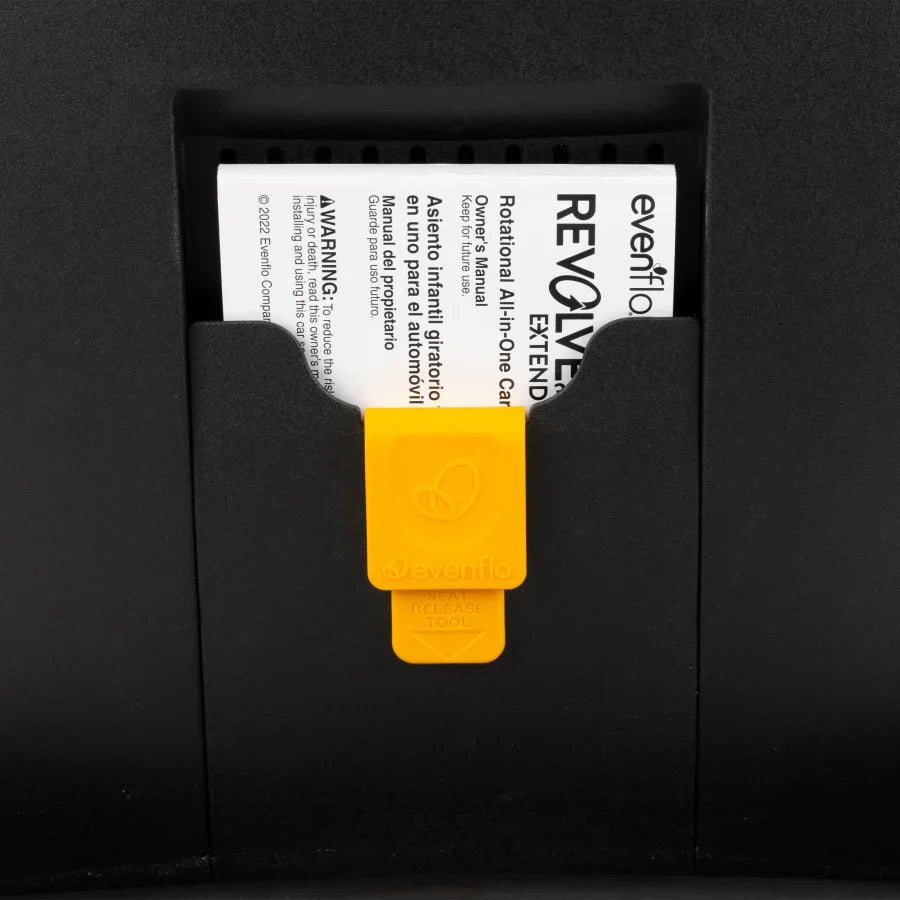 Car seat release instruction panel with yellow SEAT RELEASE tab over printed labels.