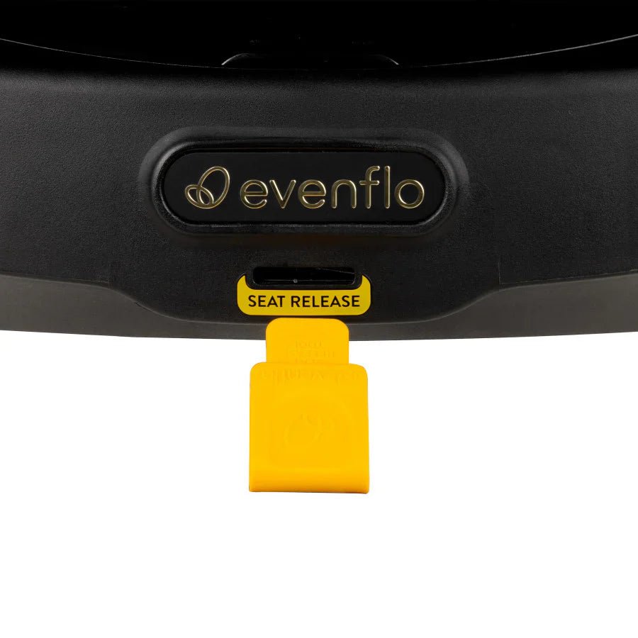 Car seat base release button area, evenflo logo on black cover with SEAT RELEASE tab.