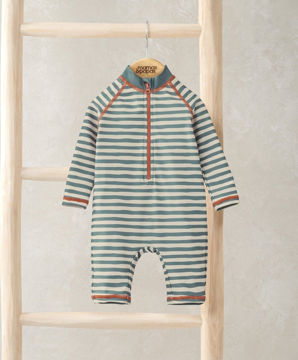 Long sleeve striped rashsuit with half-zip front, teal-and-white stripes, orange trim