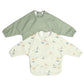 Pair of long-sleeve baby bibs: white animal print and sage green bibs.