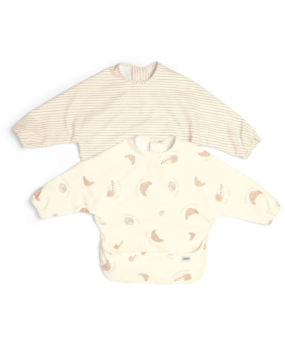 Pair of long-sleeve baby bibs: cream stripe bib and cream animal print bib.
