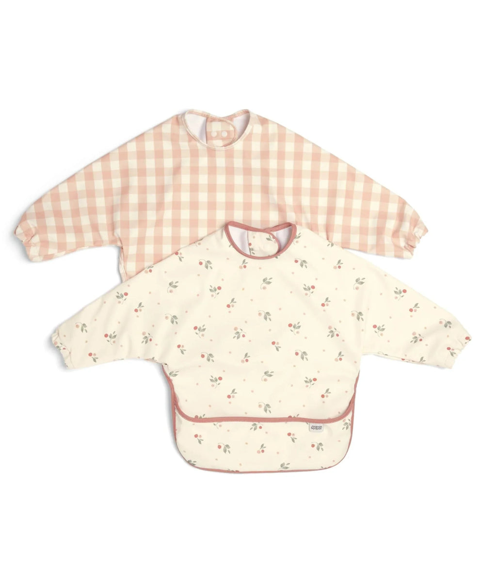 Pair of long-sleeve baby bibs: cream floral print and pink gingham bibs.
