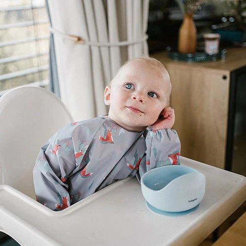 Long-sleeve baby bib with fox print, front bib panel, worn on child