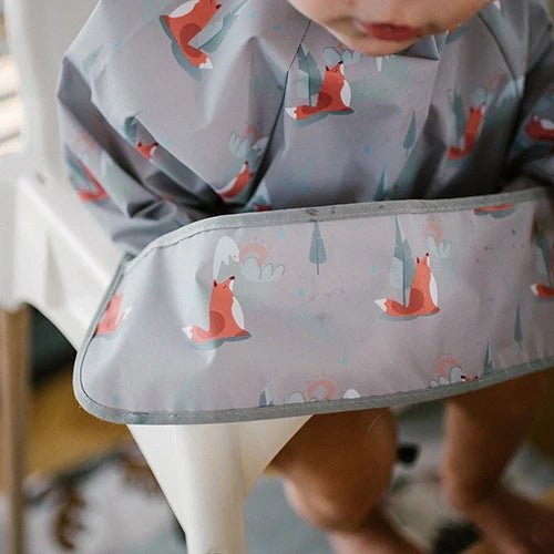 Long-sleeve baby bib detail with fox print and curved front pocket
