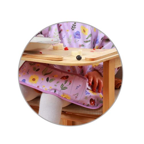 Long-sleeve bib with lavender floral print and long sleeves, adjustable neck closure