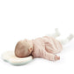 Natural Care headrest with baby lying on it, light pink outfit and swirl cover