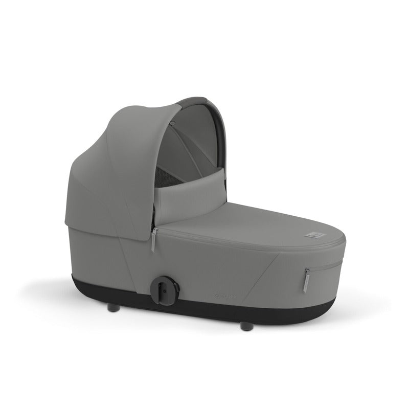 Gray carrycot with hood, open front, padded mattress and dark base