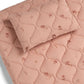 Quilted changing mat with blush pink wildflower print and padded heart quilting