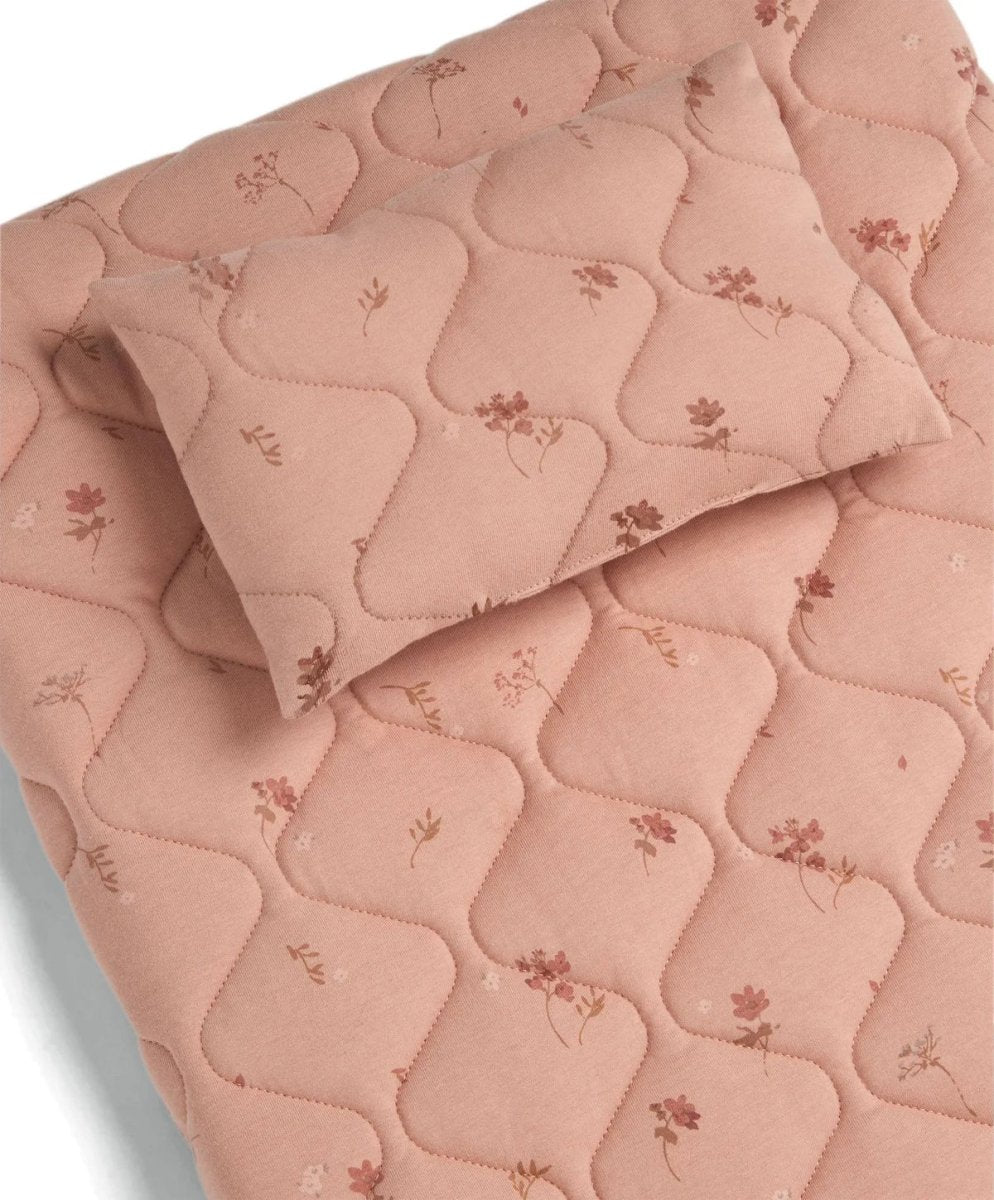 Quilted changing mat with blush pink wildflower print and padded heart quilting