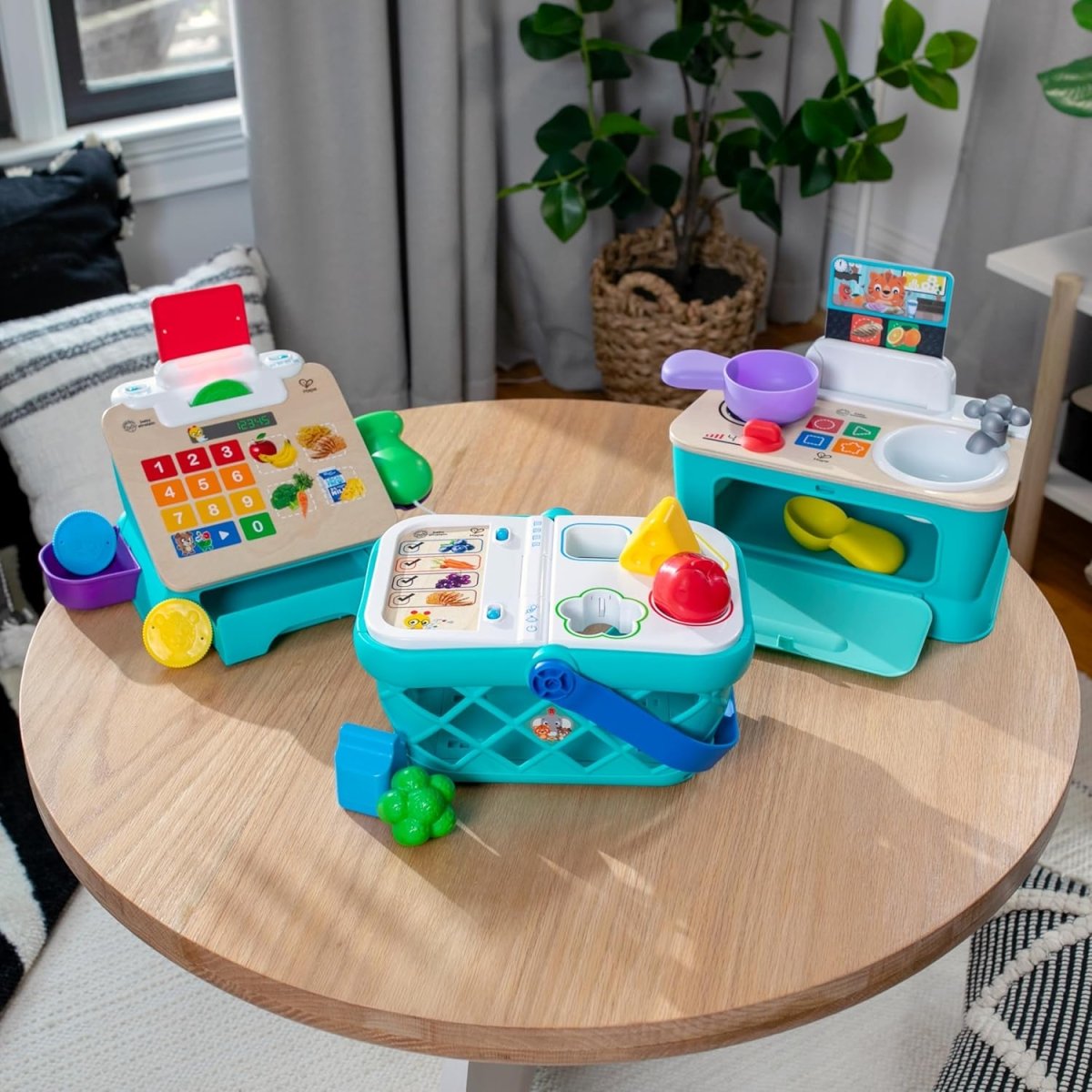 Blue and white toy cash register with keypad, scanner, and colorful play coins