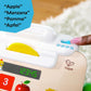Close-up of white toy card reader on cash register with green button icons and display
