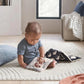 Baby playing with folding fabric book featuring fox and yin-yang patterns