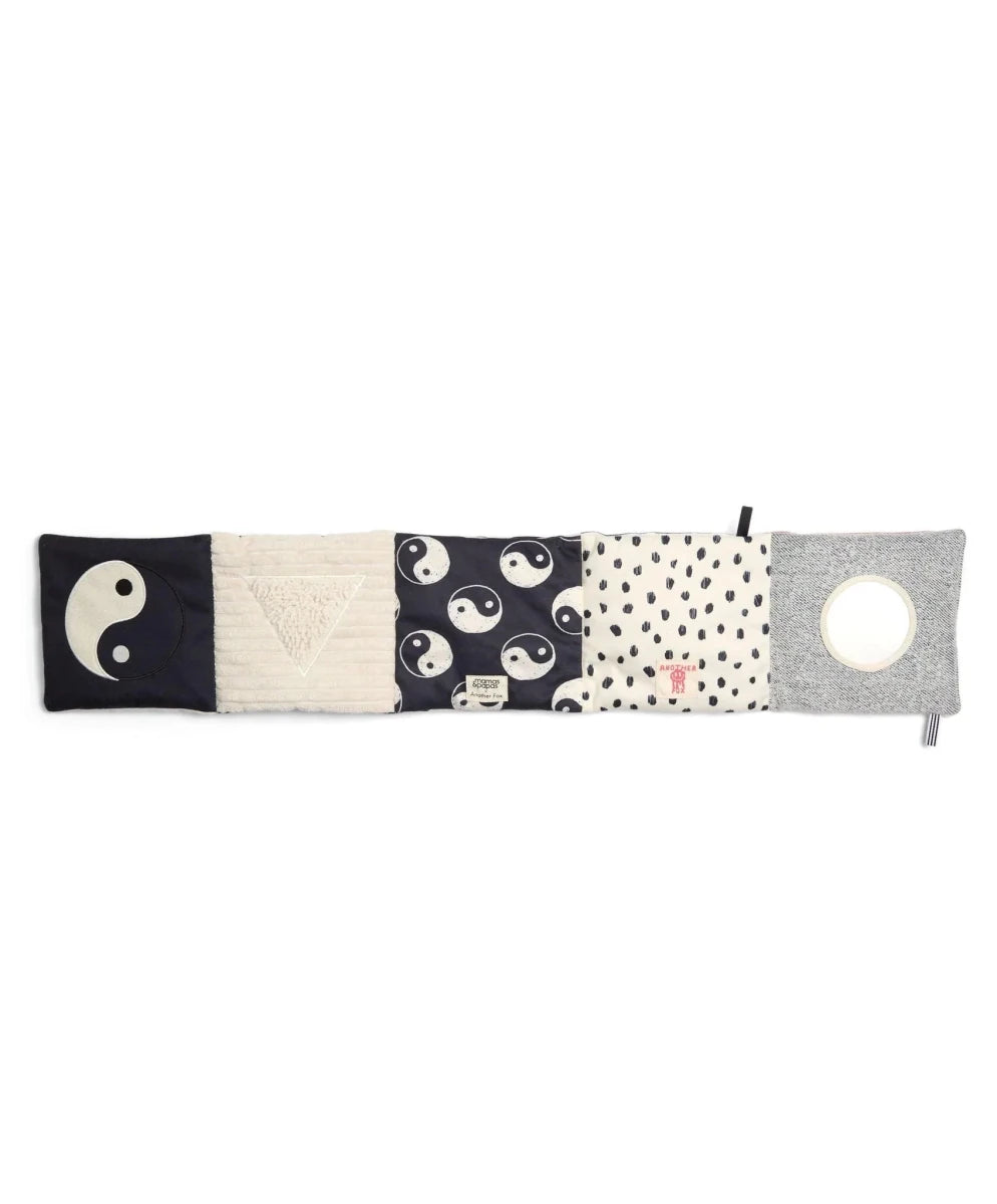 Folding fabric baby book with yin-yang fox print, polka dots, and gray patch