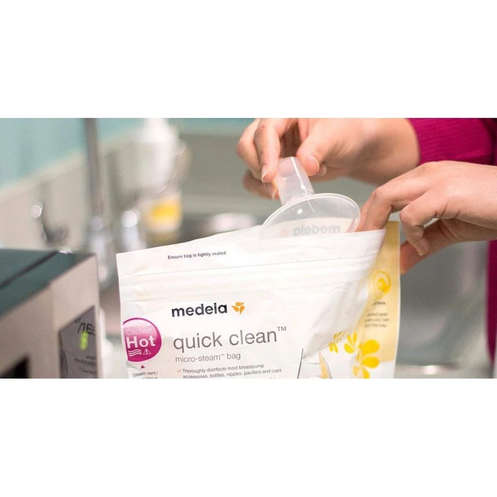 Medela Quick Clean microwave bag, white bag with logo held in hands